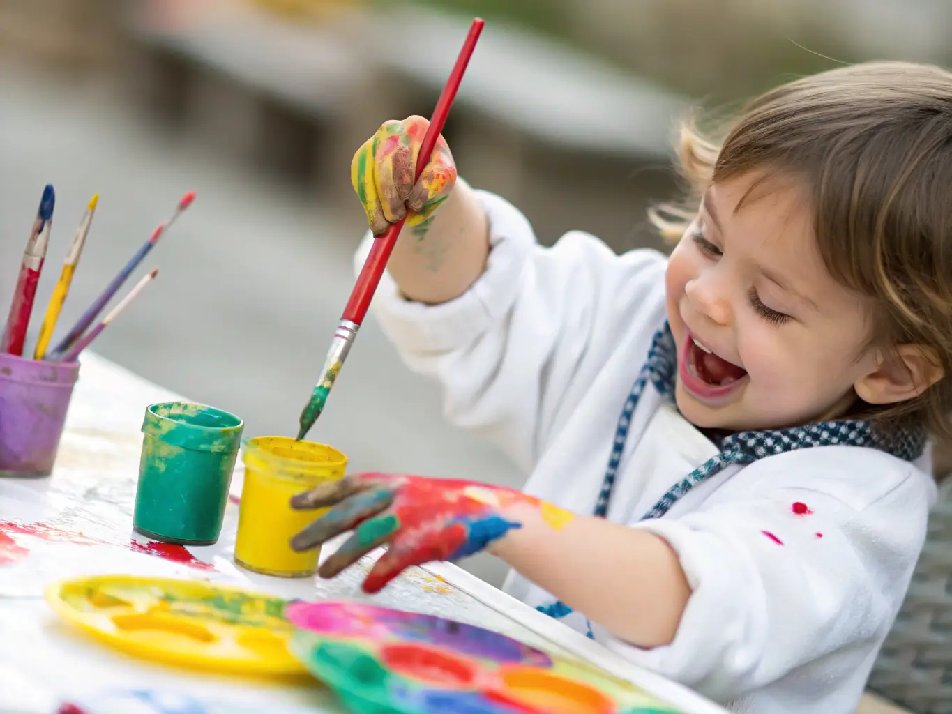 A close-up shot of a child carefully painting a scene inspired by the book, showcasing their focus and creativity.